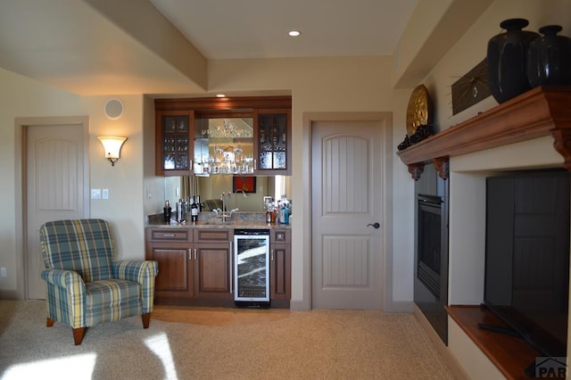 bar featuring wine cooler, recessed lighting, light colored carpet, and wet bar