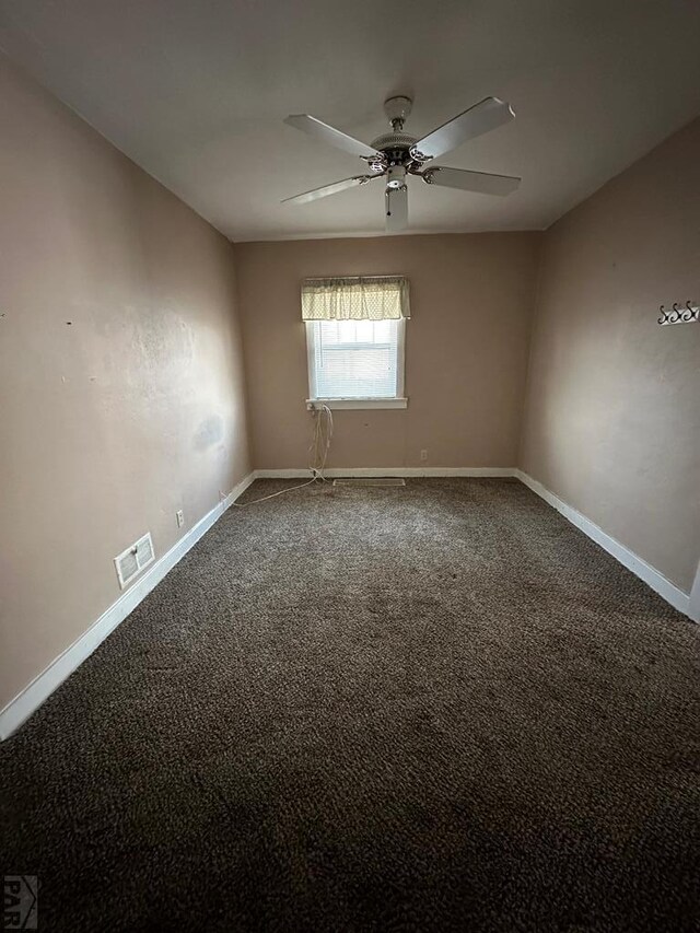 unfurnished room featuring carpet, visible vents, ceiling fan, and baseboards