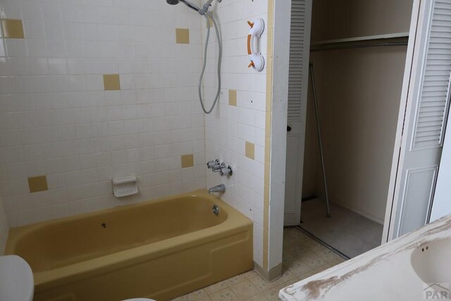 full bath with a closet, tile patterned flooring, bathtub / shower combination, and toilet