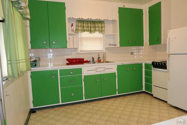 kitchen with open shelves, light countertops, freestanding refrigerator, green cabinetry, and range