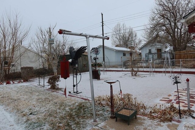 snowy yard with fence