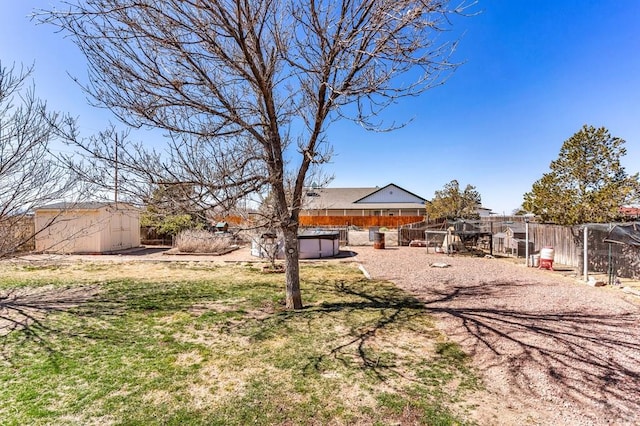 view of yard with exterior structure, a storage shed, an outdoor structure, and fence