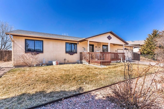 ranch-style house with brick siding, an attached garage, a front lawn, and fence