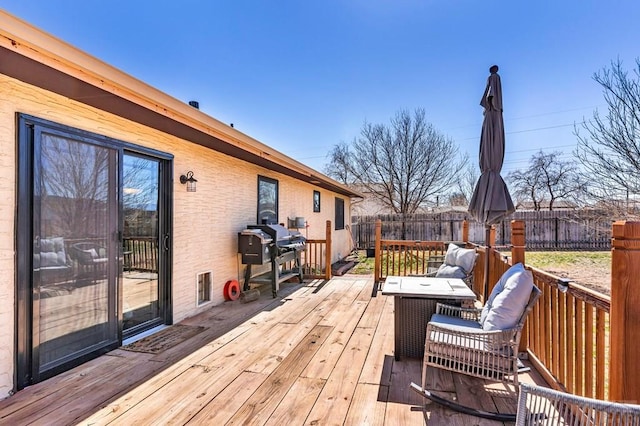 deck featuring area for grilling and fence