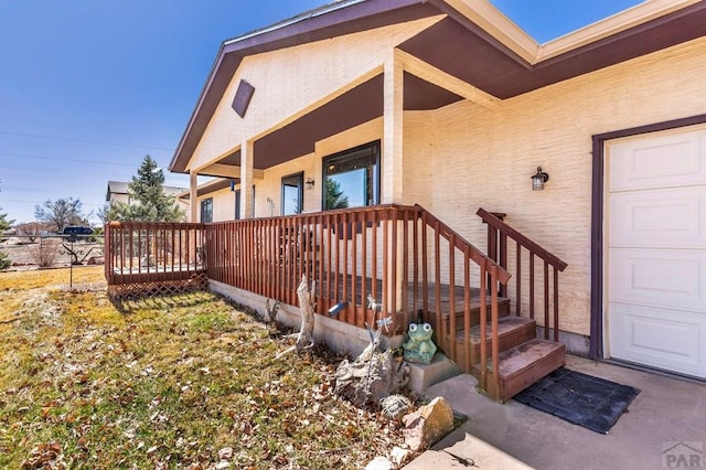 property entrance featuring a garage and covered porch