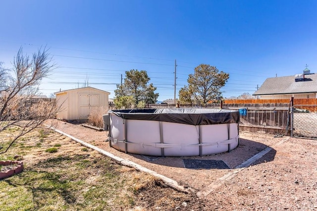 view of yard featuring a fenced in pool, a storage shed, an outdoor structure, and fence