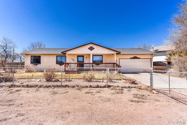 ranch-style home with a garage, driveway, a fenced front yard, and roof with shingles