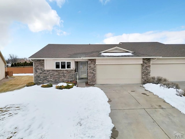 ranch-style house with driveway, a garage, and fence