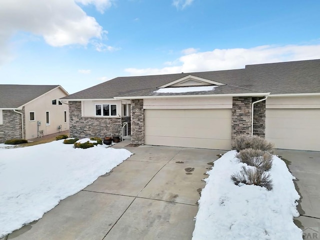 ranch-style house featuring concrete driveway, stone siding, an attached garage, and a shingled roof