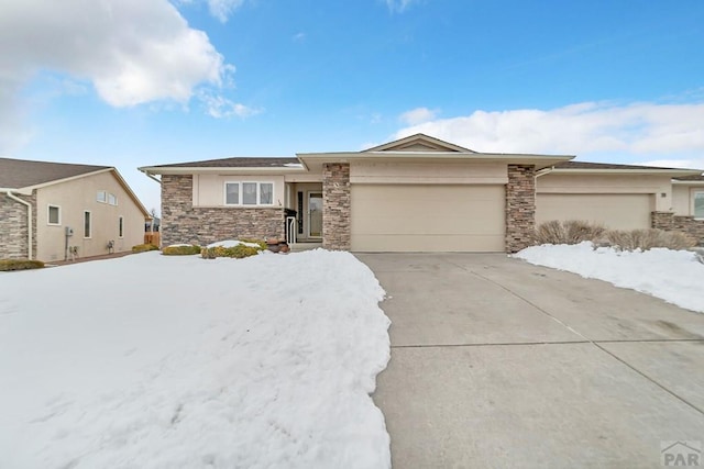 view of front of property with a garage, concrete driveway, and stucco siding