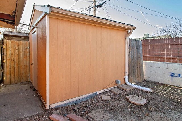 view of shed featuring fence