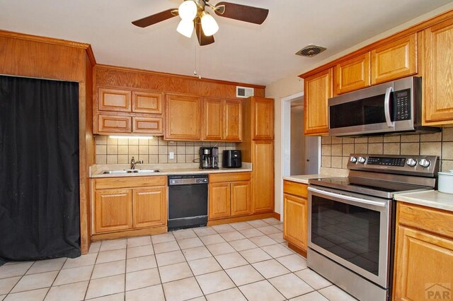 kitchen featuring visible vents, appliances with stainless steel finishes, light countertops, and a sink