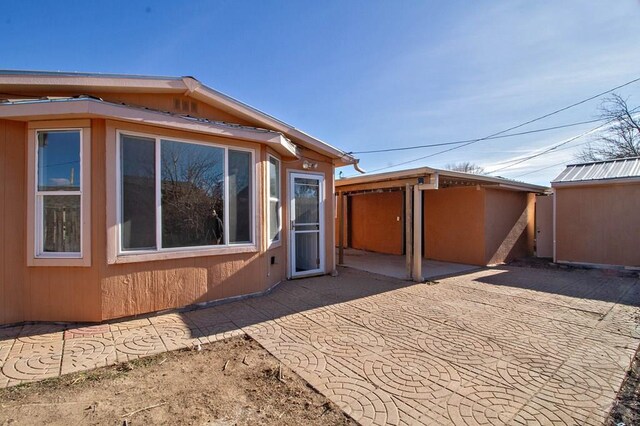 view of side of home featuring a patio