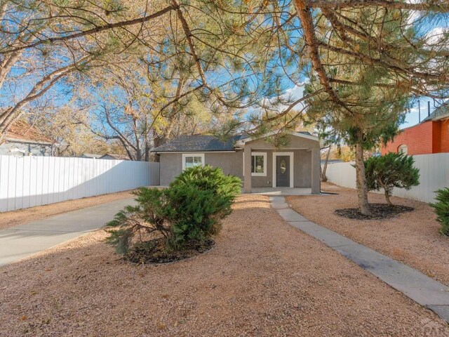 view of front of home featuring fence private yard and stucco siding