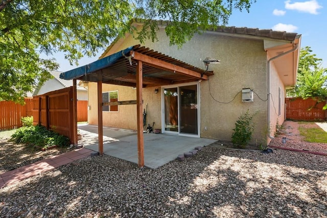 back of property with a patio area, fence, and stucco siding