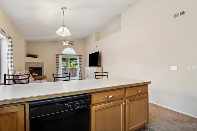 kitchen featuring black dishwasher, a lit fireplace, open floor plan, and light countertops