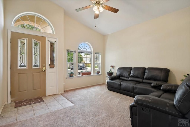 carpeted living area featuring high vaulted ceiling, tile patterned flooring, and a ceiling fan