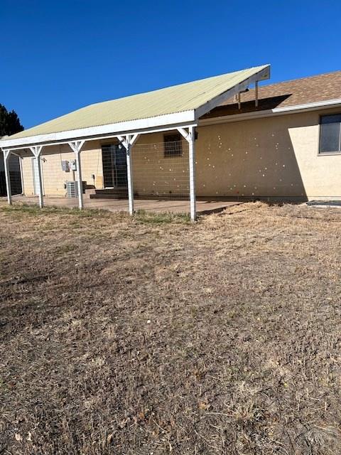 rear view of property with stucco siding