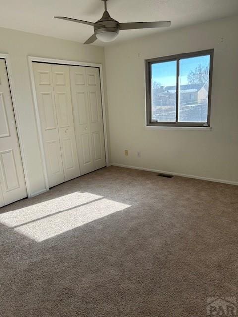 unfurnished bedroom featuring carpet flooring, ceiling fan, and baseboards