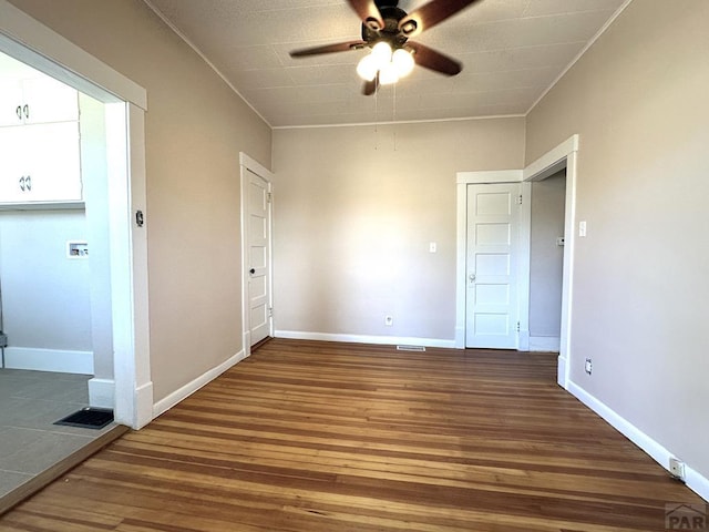 519 Broadway Ave, Pueblo, CO 81004 - spare room with visible vents, ceiling fan, baseboards, and wood finished floors