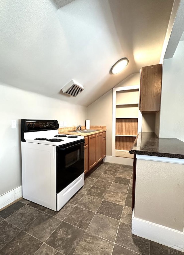 519 Broadway Ave, Pueblo, CO 81004 - kitchen featuring range with electric cooktop, a sink, lofted ceiling, and baseboards