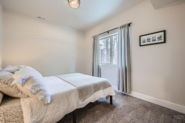 bedroom with carpet floors, visible vents, and baseboards