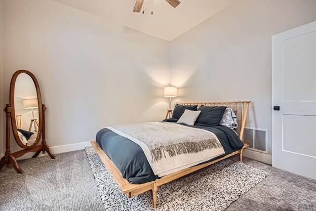 carpeted bedroom with lofted ceiling, a ceiling fan, visible vents, and baseboards