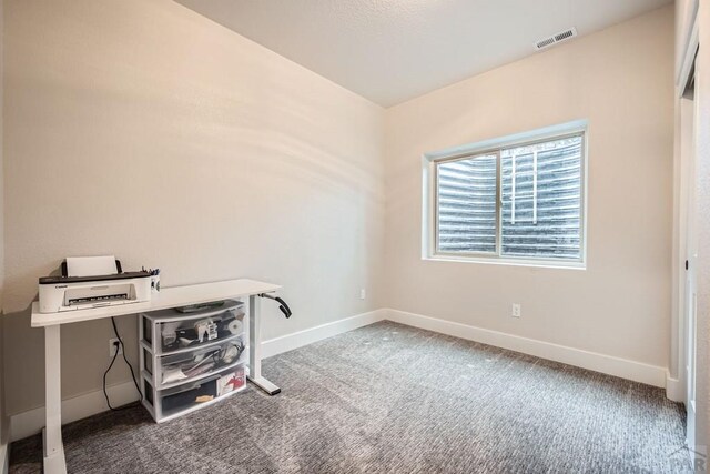 office space featuring carpet floors, visible vents, and baseboards