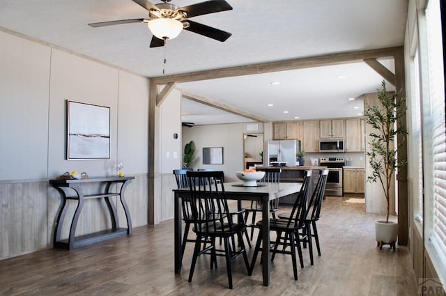 dining room with ceiling fan, beamed ceiling, dark wood-type flooring, and recessed lighting