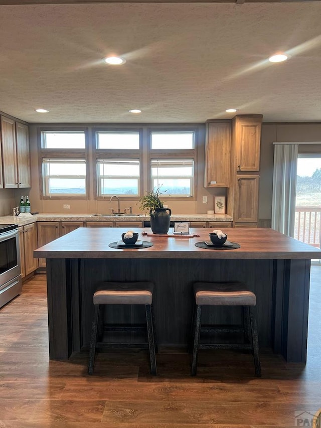 kitchen featuring wood counters, a kitchen island, and a breakfast bar