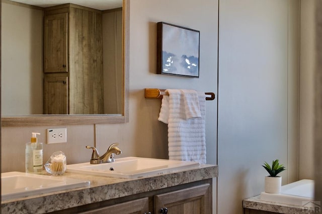 full bathroom featuring double vanity and a sink