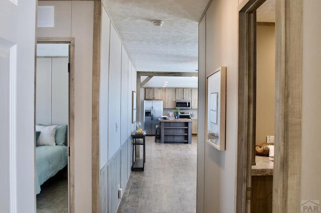 hallway with dark wood-style floors and a textured ceiling