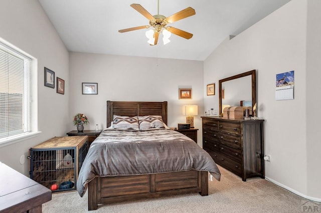 bedroom with light carpet, ceiling fan, baseboards, and lofted ceiling