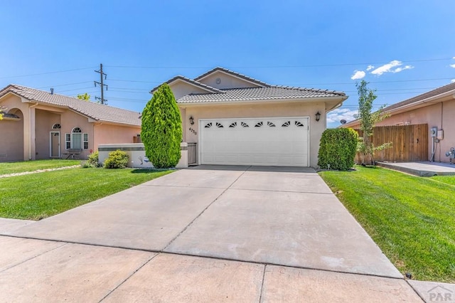 ranch-style home featuring a front yard, concrete driveway, a tile roof, and stucco siding