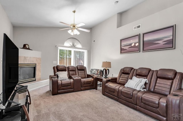 living room with visible vents, a ceiling fan, light colored carpet, lofted ceiling, and a fireplace