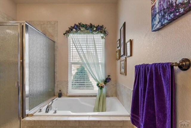 full bathroom with a garden tub and a shower stall