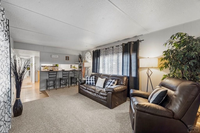 living room featuring light carpet and a textured ceiling