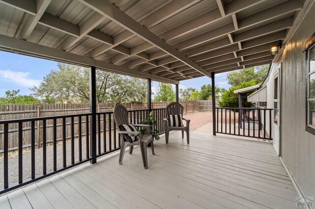 deck with a fenced backyard