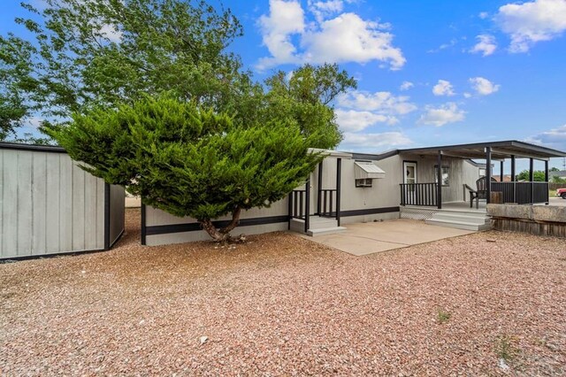 rear view of house featuring a patio area and fence