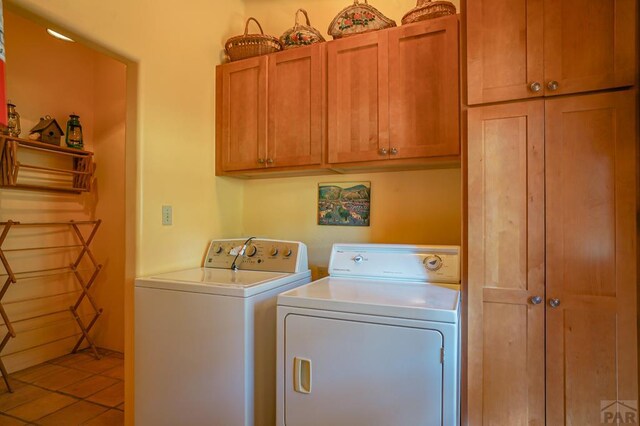 laundry room with tile patterned flooring, cabinet space, and independent washer and dryer