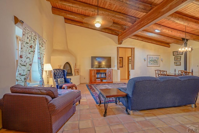 living area with wood ceiling, a notable chandelier, beamed ceiling, and light tile patterned floors