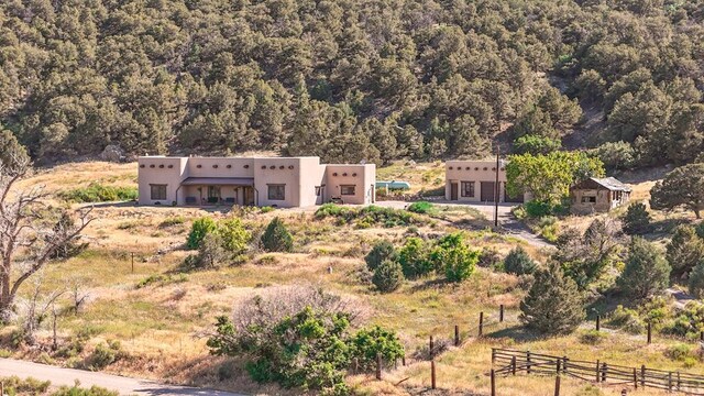 birds eye view of property featuring a rural view and a wooded view