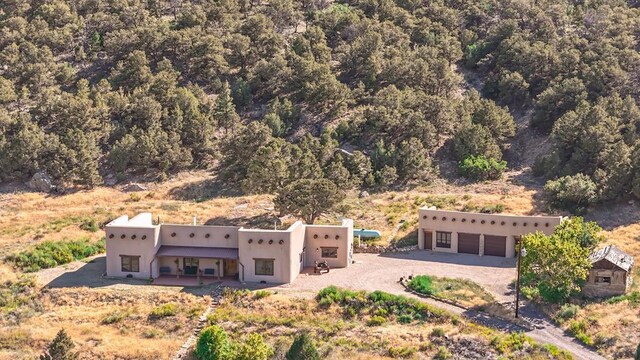 birds eye view of property featuring a view of trees