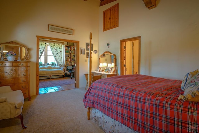 bedroom with light carpet and a towering ceiling