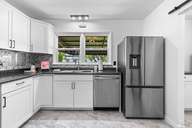1121 Alexander Cir, Pueblo, CO 81001 - kitchen with stainless steel appliances, white cabinets, backsplash, and baseboards