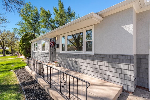 1121 Alexander Cir, Pueblo, CO 81001 - property entrance with stucco siding and a lawn