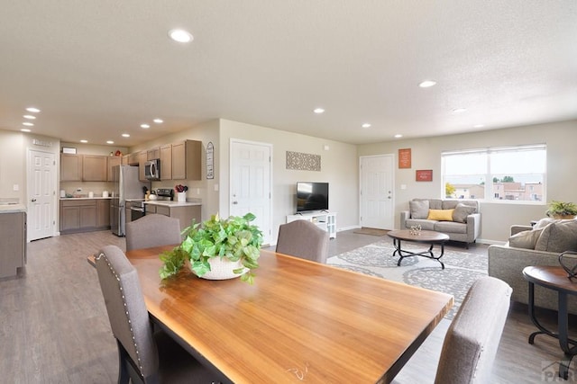 dining room featuring recessed lighting, baseboards, and wood finished floors