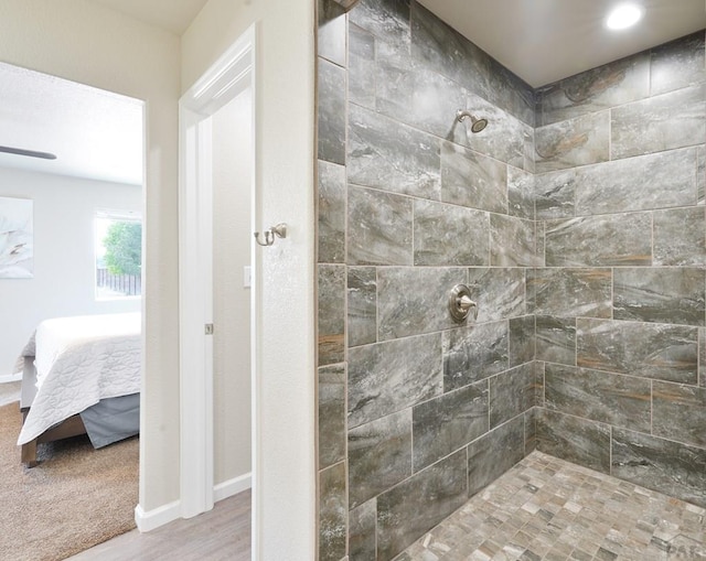 full bathroom featuring baseboards, walk in shower, and connected bathroom