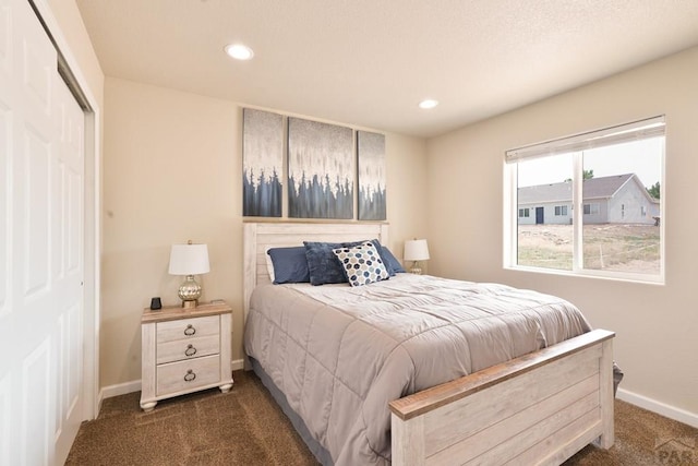 bedroom featuring baseboards, dark carpet, a closet, and recessed lighting