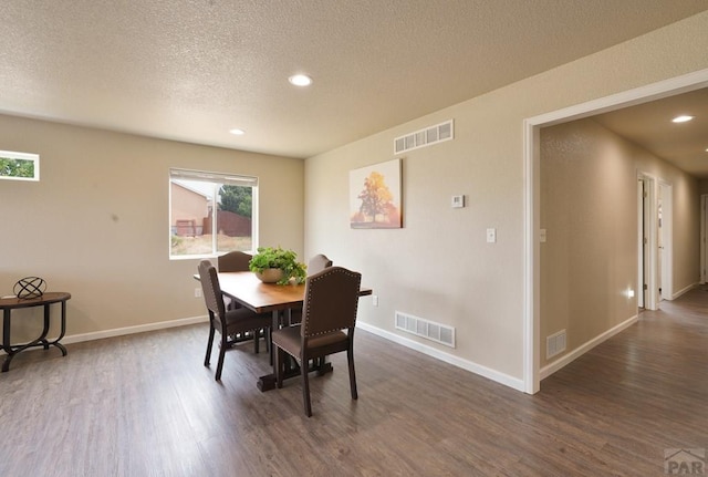 dining area with dark wood-style floors and visible vents